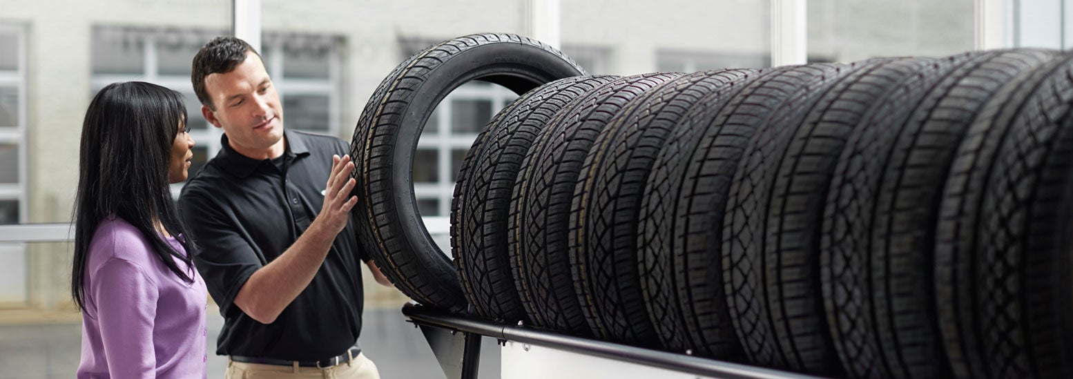 Subaru service representative showing customer a tire. | Jenkins Subaru in Bridgeport WV
