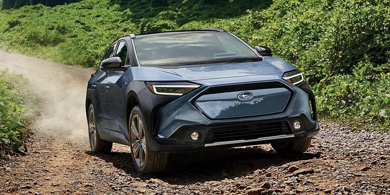 Subaru electric Solterra driving on a dirt road
